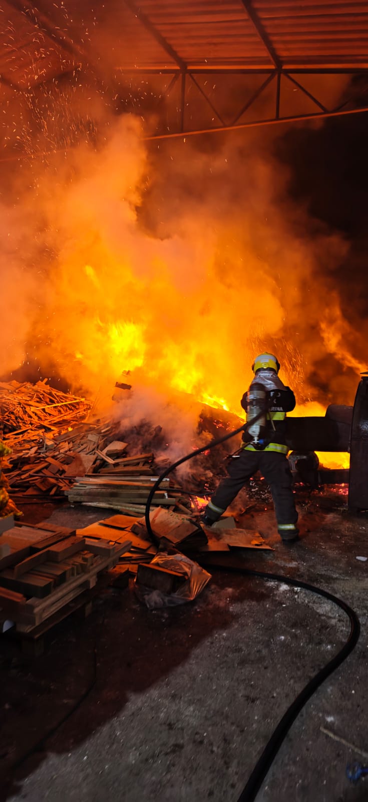 Fire burns wood pile outside potato-chip factory in Santa Rosa do Sul
